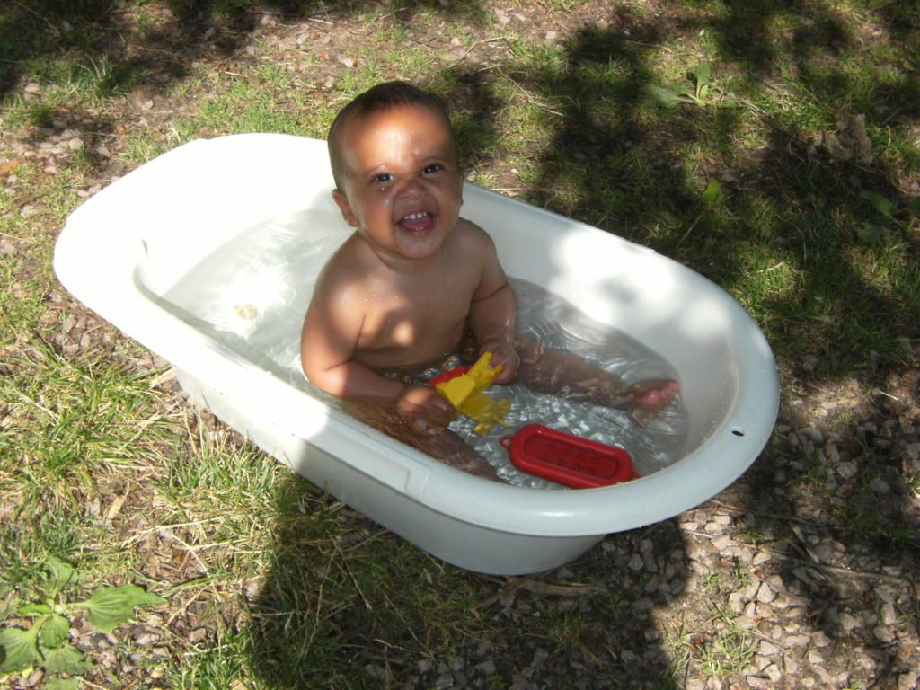 small kid bathing in cold water