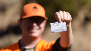 hunter holding hunting license